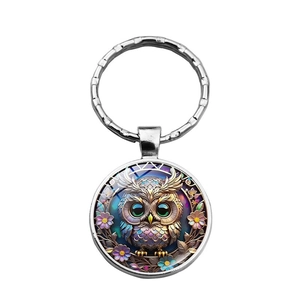 Detailed macro view of an owl illustration pendant key ring with colorful floral accents