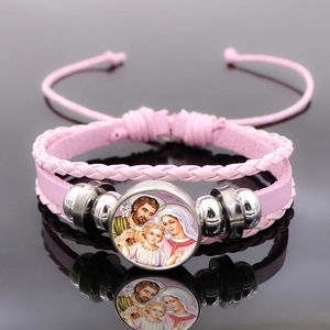 Detailed macro view of pink braided leather bracelet with Virgin Mary glass dome charm