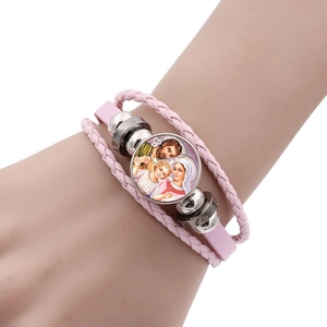 Close-up of pink layered leather bracelet with Religious Catholic Holy Family glass cabochon