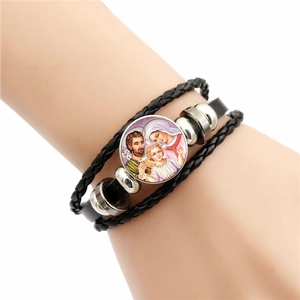 Detail of multi-layer leather bracelet with Virgin Mary glass pendant and woven beads