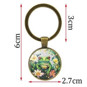 Portachiavi vintage in metallo con illustrazione di rana e fiori sotto cupola di vetro