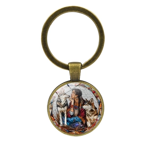 Vintage bronze keychain featuring native woman and wolf design with glass dome cover