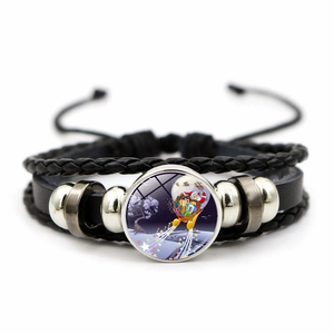 Detalle de pulsera de cuero trenzado con colgante de cristal de Papá Noel y cuentas plateadas