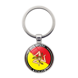 Detailed macro of silver Sicilia Trinacria keychain with glass dome and Italian flag motif