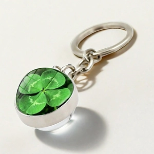 Detailed macro view of silver clover keychain pendant with clear double-sided crystal ball