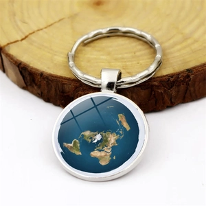 Flat earth map pendant keychain with round metal base and clear glass dome on wood block