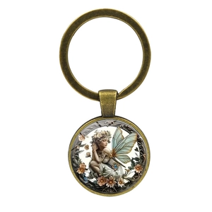 Vintage bronze keychain with a glass cabochon pendant featuring a fairy flower illustration