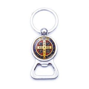 Macro detail of the Saint Benedict Medal keychain featuring an integrated bottle opener tool