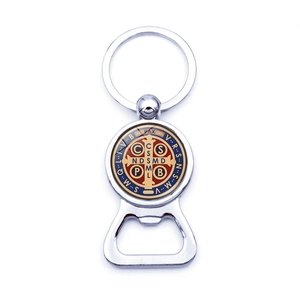 Detailed macro view of the Saint Benedict medal integrated into a metal bottle opener keychain