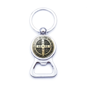 Detail of Saint Benedict Medal bottle opener keychain with polished silver and brass finish