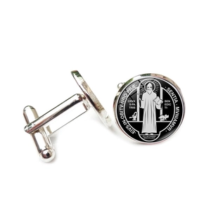 Detailed view of Saint Benedict Medal cufflinks with silver base and black religious motif