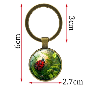 Marienkäfer Schlüsselanhänger mit Glasanhänger in Bronzeoptik und grünen Blättern 6cm