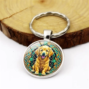 Golden Retriever puppy keychain pendant with green leaf pattern on a wooden background