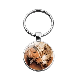 Silver metal keychain featuring a circular horse portrait pendant on a white background