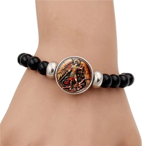 Saint Michael Archangel beaded bracelet with black beads and religious pendant on wrist