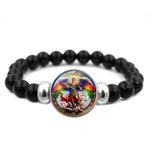 Detailed macro view of Saint Michael Archangel religious cabochon and black beads