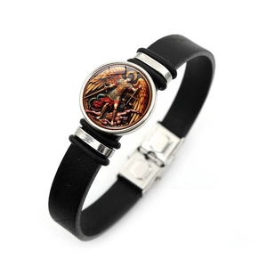 Close-up of black leather Saint Michael Archangel bracelet with vintage silver charms