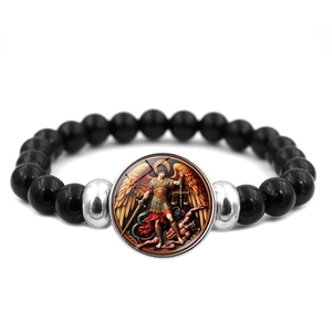 Close-up of Saint Michael Archangel beaded bracelet with polished black stones and pendant