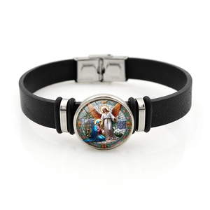Macro detail of Archangel Michael religious glass cabochon on black leather bracelet