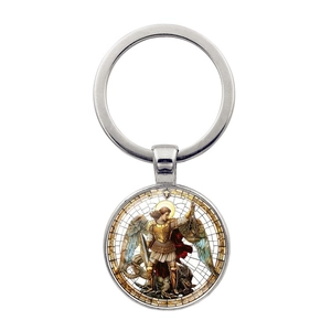 Macro view of Archangel Saint Michael silver keychain with sword and scales detail
