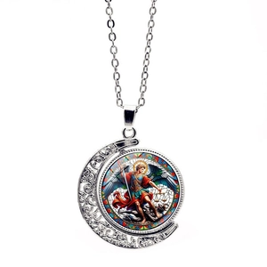Detailed close-up of Archangel Michael spinning moon pendant with colorful glass art