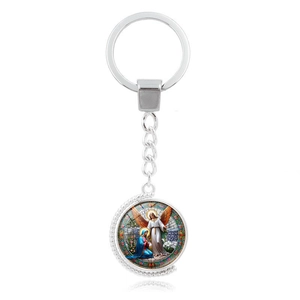 Close-up of Archangel Michael rotating metal keychain with colorful religious pendant