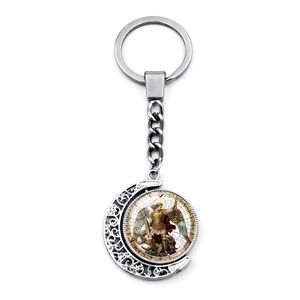 Detail of silver moon keychain with rotating Archangel Michael pendant and art illustration
