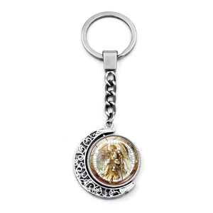 Detail of Archangel Saint Michael rotating moon keychain with silver metal engraving