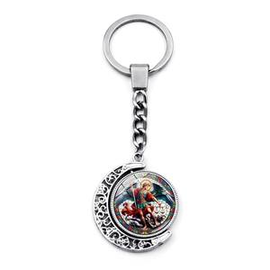 Close-up of Saint Michael rotating moon keychain with silver hollow design