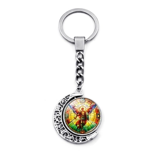 Detail showing Archangel Saint Michael rotating moon keychain in silver alloy metal