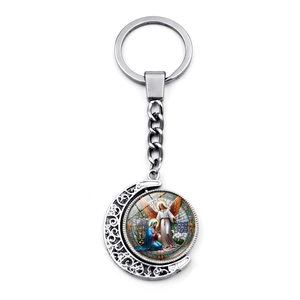 Detail of silver St. Michael Archangel keychain with rotating moon pendant and glass dome