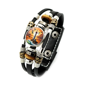 Close-up of leather bracelet featuring lighthouse glass gem and adjustable metal snaps