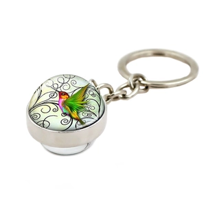 Llavero de bola de cristal con colibrí, motivo floral vintage y anillo de metal plateado