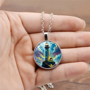 Macro shot of silver pendant with glass lighthouse illustration on a cross chain
