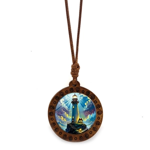 Macro shot of circular wood pendant necklace featuring a lighthouse landscape illustration