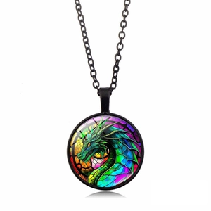Detail of a round glass cabochon pendant necklace with a colorful dragon pattern and black chain