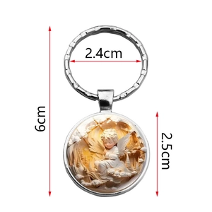 Silver metal angel pendant keychain with embossed design and clear glass dome cover