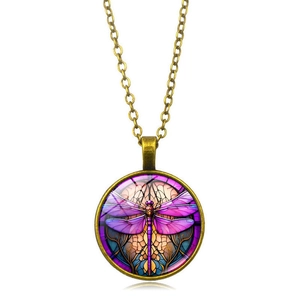 Detailed view of vintage bronze dragonfly pendant with purple glass inlay and art deco style