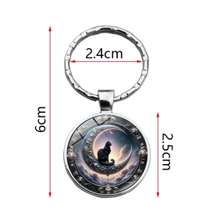 Metal keychain featuring a black cat on a moon with dimensions 6cm by 2.5cm