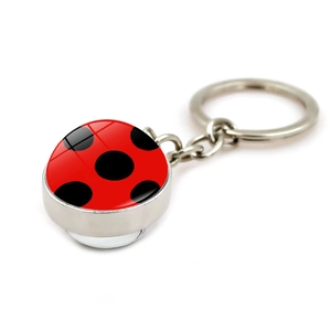 Polished silver metal keychain featuring a glass dome ladybug red polka dot pendant charm