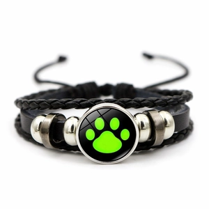Multilayer braided leather bracelet featuring a green paw print glass dome charm