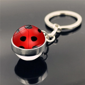 Ladybug pattern spherical keychain with red black dots and polished silver metal ring