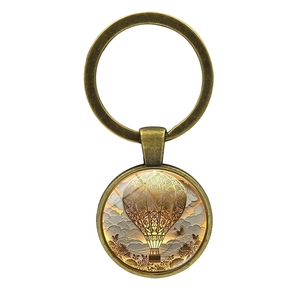 Porte-clés vintage en bronze avec motif de montgolfière et détails de mandala