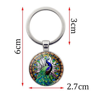 Peacock glass pendant keychain in metal, showing dimensions of 6cm length and 3cm ring