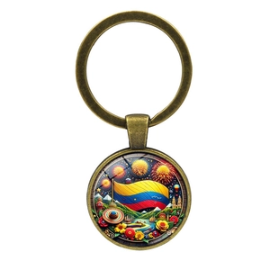 Vintage bronze Colombia flag keychain with landmarks and fireworks on a white background