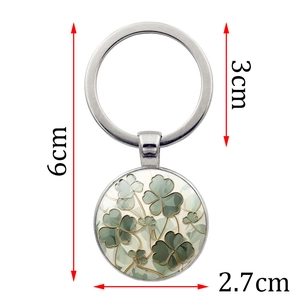 Fashionable four-leaf clover keychain with green gradient pendant on white background