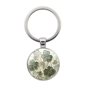 Silver four-leaf clover keychain with green enamel pendant on a white background