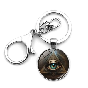 Detailed macro view of the silver Eye of Providence keychain with glass dome and lobster clasp