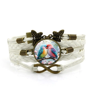 Détail d'un bracelet tissé multicouche avec dôme en verre inséparables et breloques