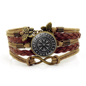 Macro shot of multilayer braided bracelet with Viking compass and infinity charm
